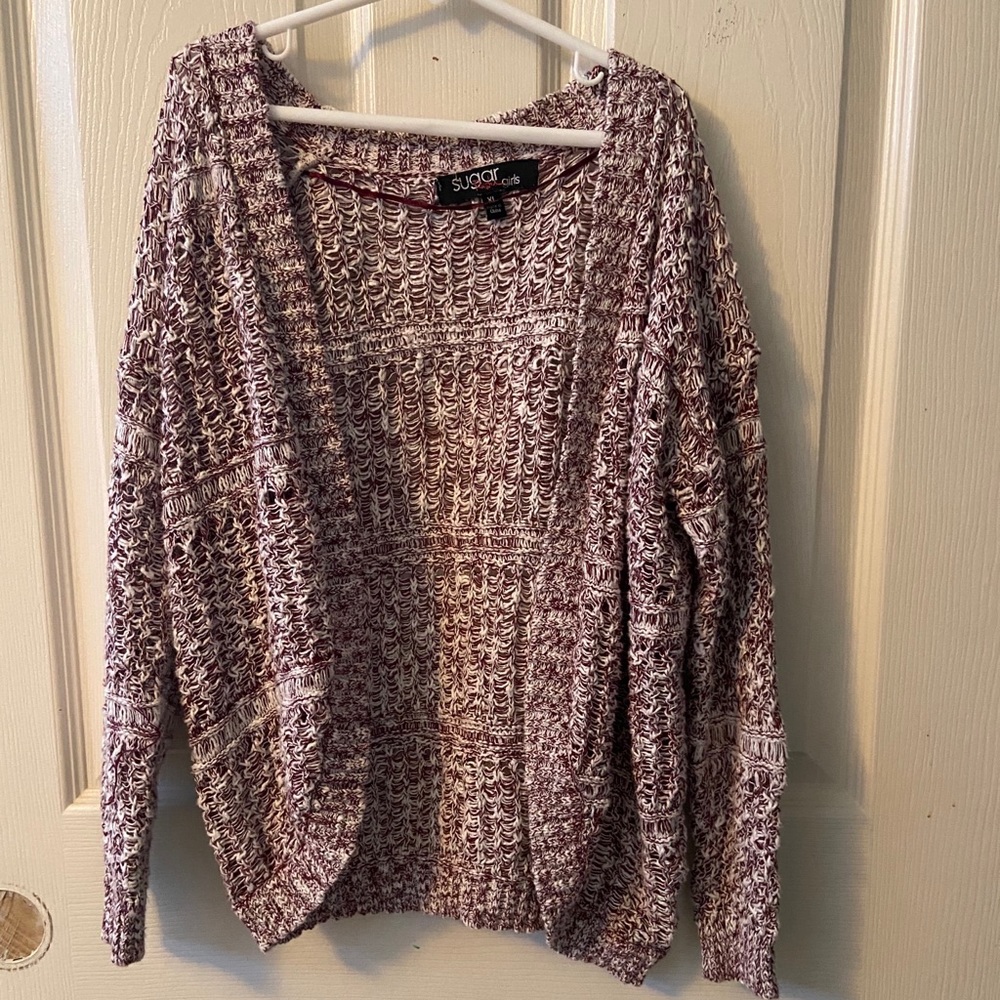 Purple and white sweater.